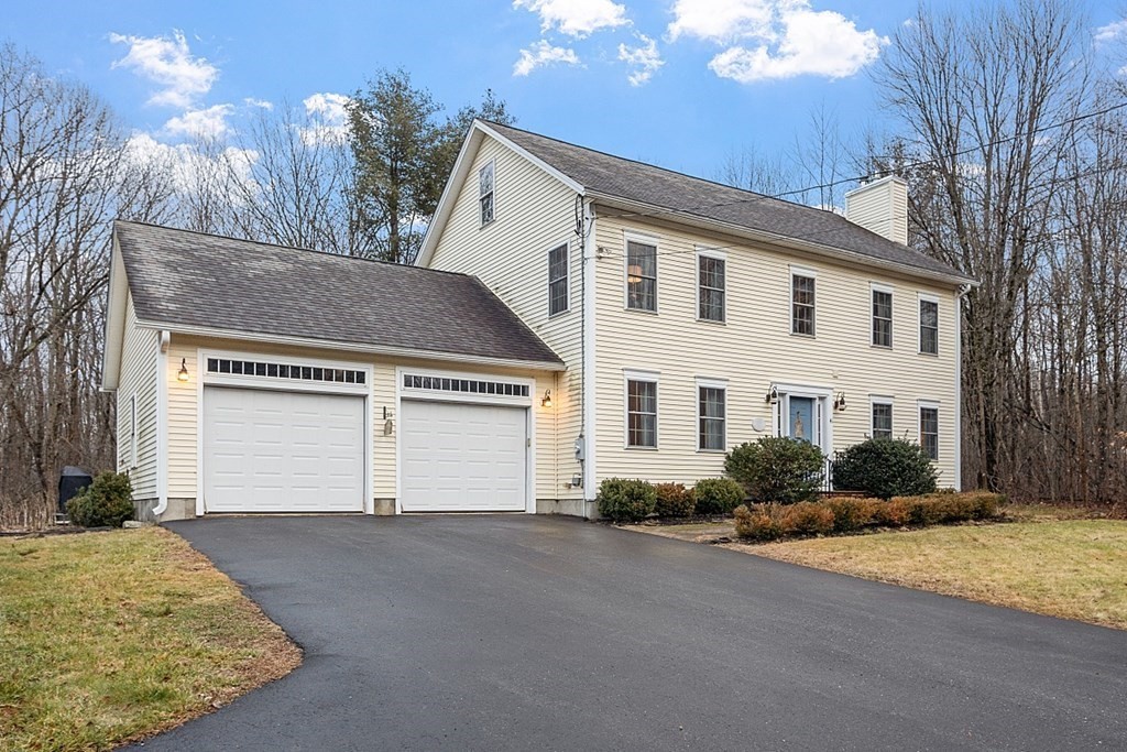 41 Willard Road Ashburnham, MA 01430 - Photo 1 of 42 a front view of a house with a yard and garage