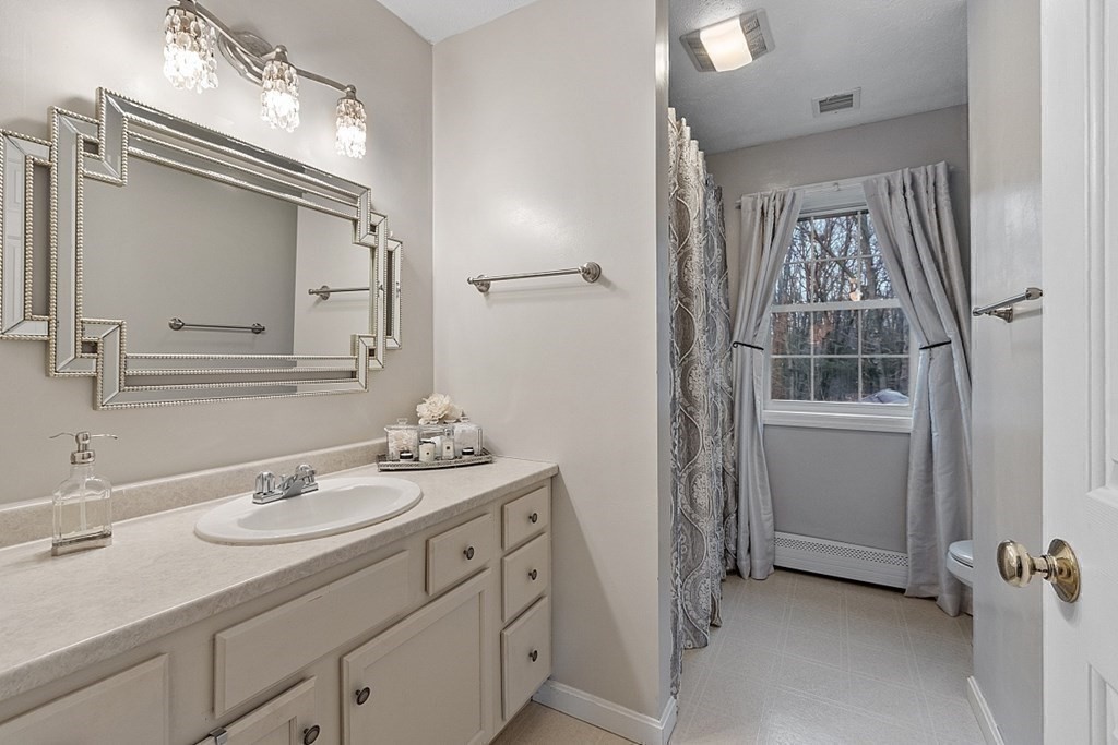 41 Willard Road Ashburnham, MA 01430 - Photo 22 of 42 a bathroom with a sink a mirror a vanity and a shower