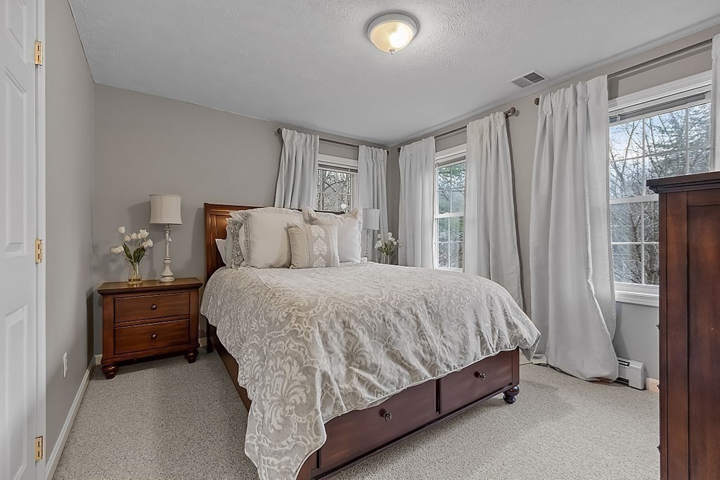 41 Willard Road Ashburnham, MA 01430 - Photo 27 of 42 a bed sitting in a bedroom next to a window