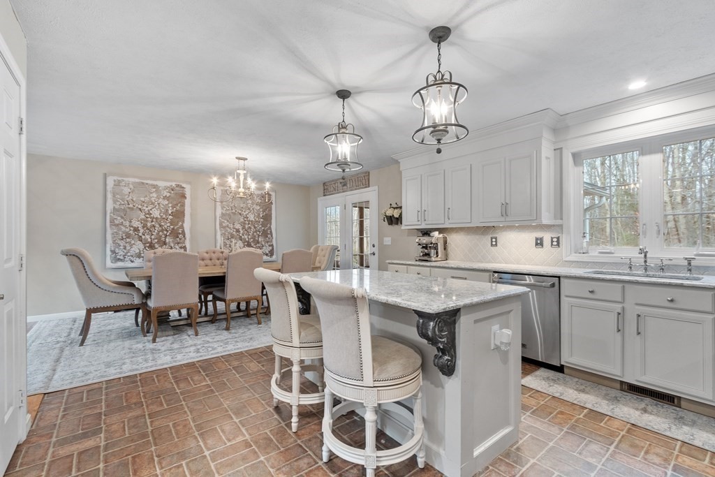 41 Willard Road Ashburnham, MA 01430 - Photo 4 of 42 a kitchen with a dining table chairs sink and cabinets