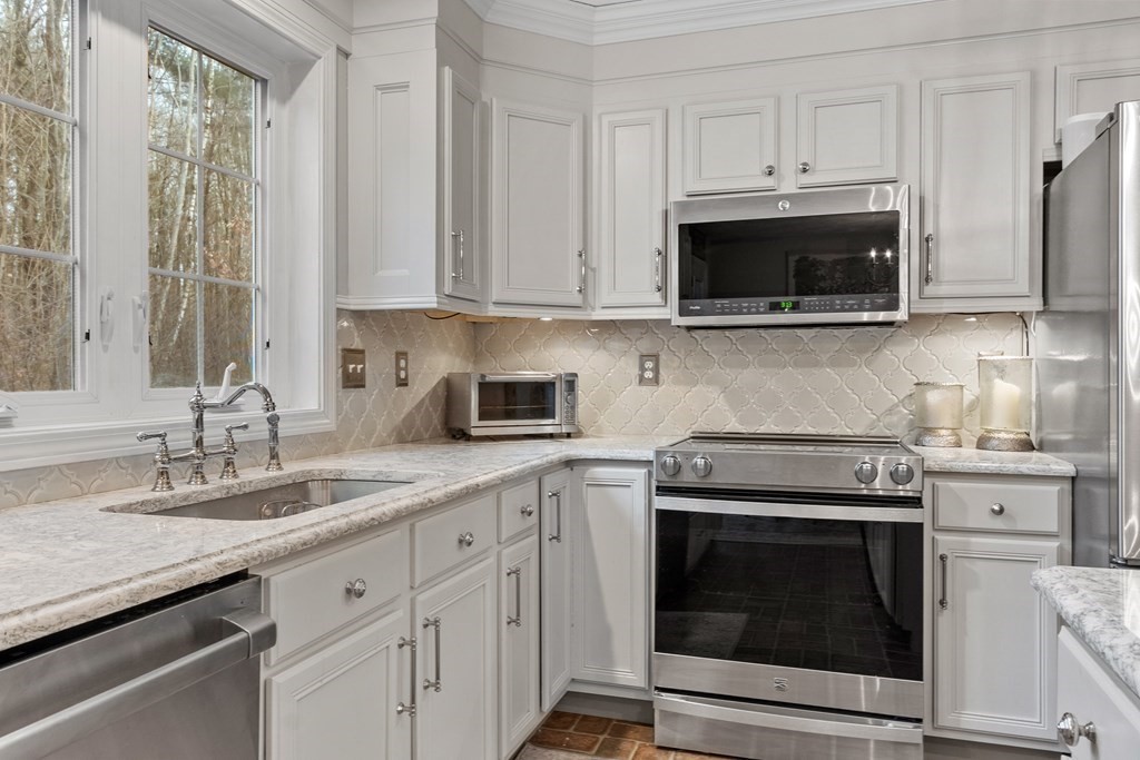 41 Willard Road Ashburnham, MA 01430 - Photo 5 of 42 a kitchen with cabinets stainless steel appliances a sink and a microwave