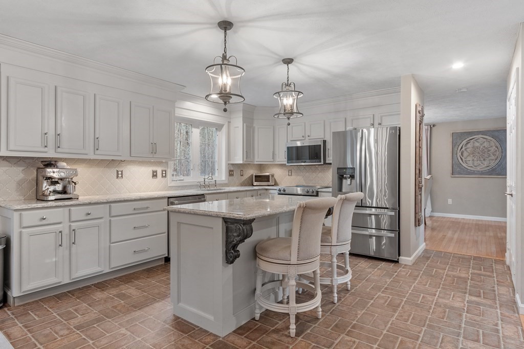 41 Willard Road Ashburnham, MA 01430 - Photo 6 of 42 a kitchen with stainless steel appliances granite countertop a sink a stove a refrigerator cabinets and chairs