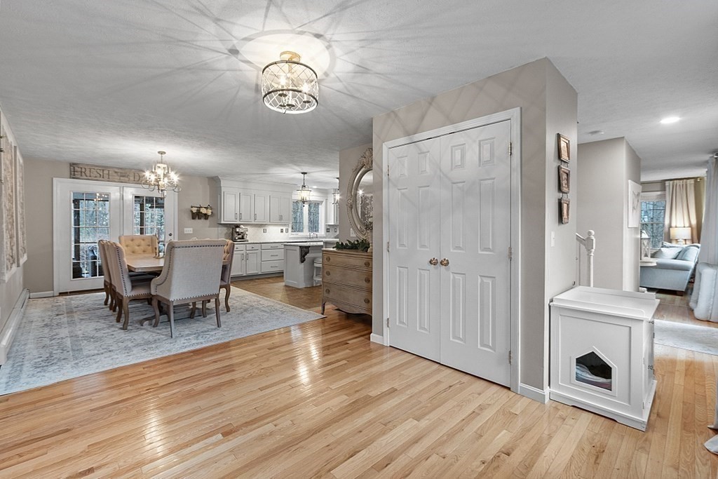 41 Willard Road Ashburnham, MA 01430 - Photo 7 of 42 a view of a dining room and livingroom with furniture wooden floor a chandelier