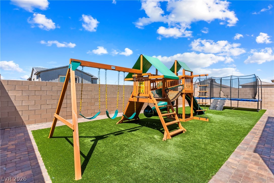 320 Isla Enclave Way Henderson, NV 89011 - Photo 35 of 49 This spacious private yard offers a vibrant playground and trampoline, perfect for outdoor recreation.