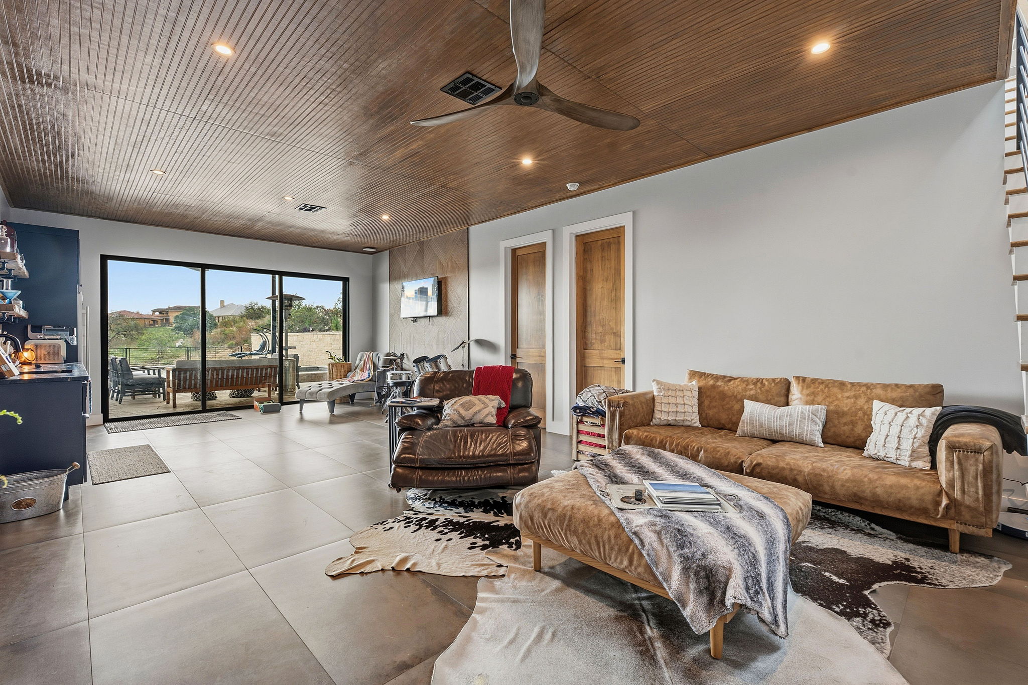 194 Placid Way Spring Branch, TX 78070 - Photo 21 of 37 Spacious living area featuring a wood-finish plank ceiling with recessed lighting, large format tile flooring, and a contemporary ceiling fan