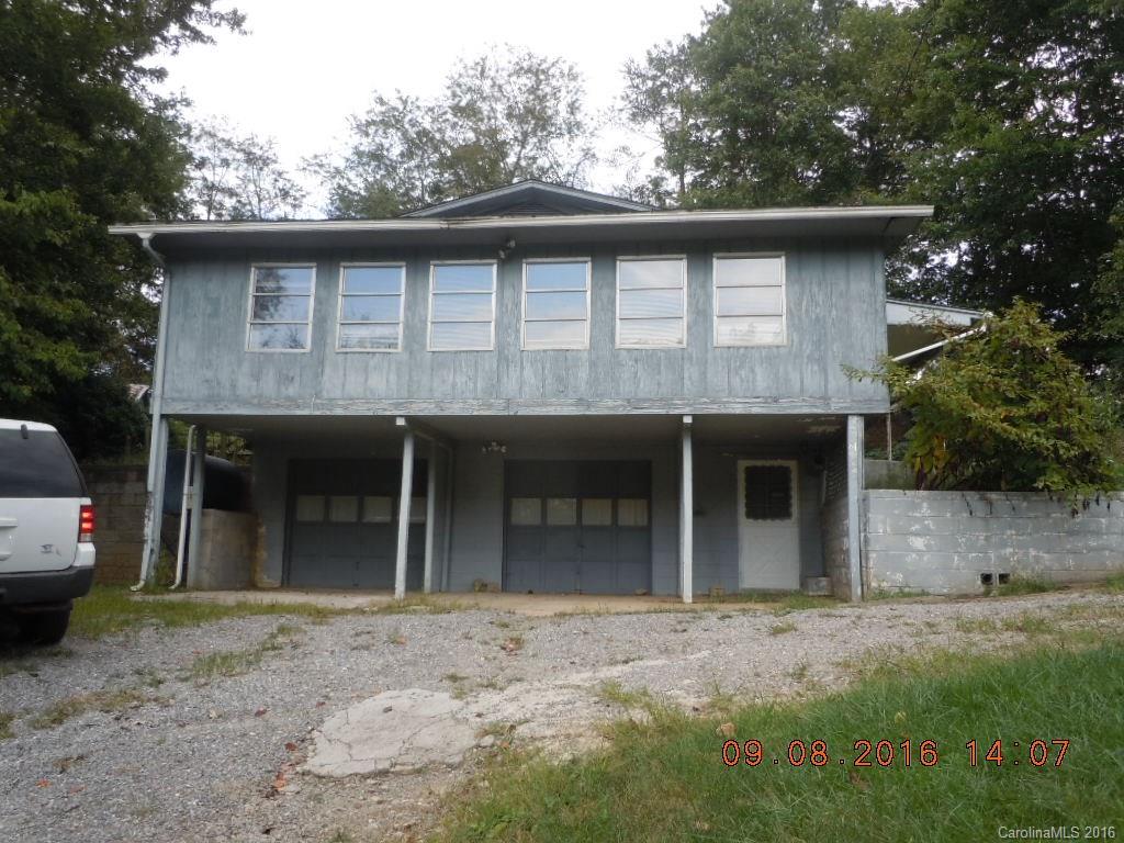 61 Stroupe Road Canton, NC 28716 - Photo 1 of 10 a front view of a house with a garden