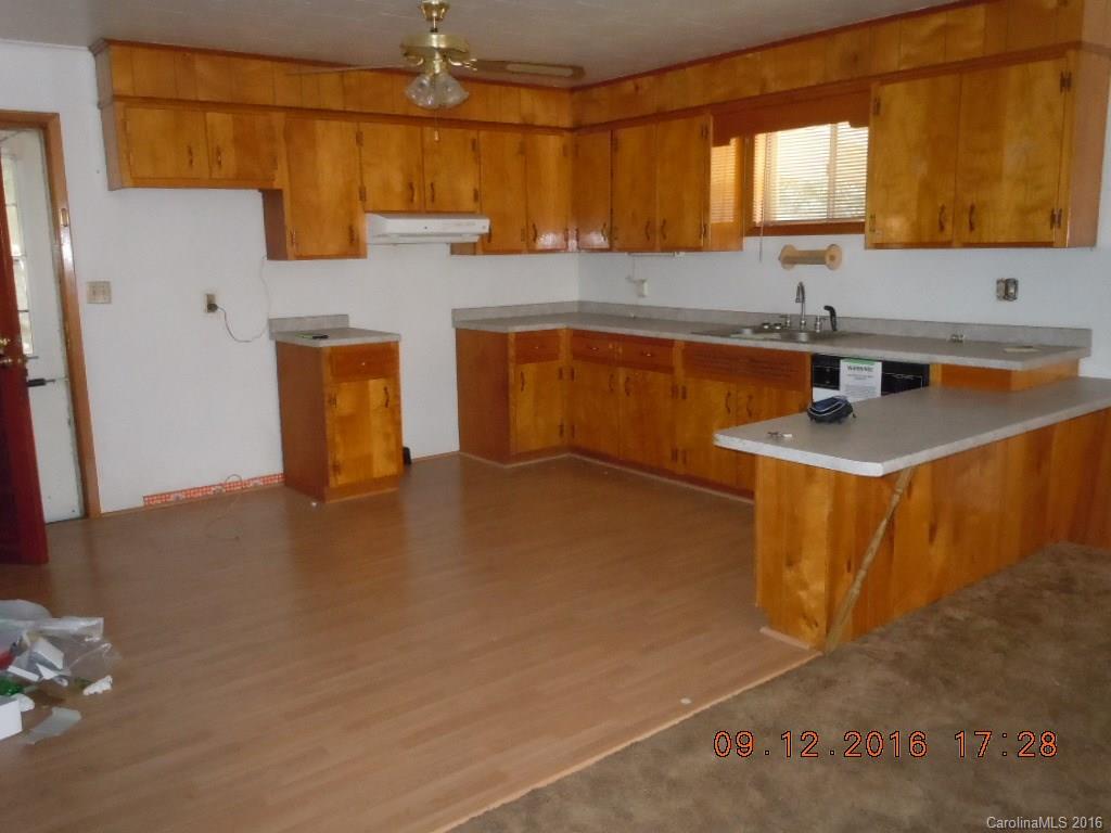 61 Stroupe Road Canton, NC 28716 - Photo 5 of 10 a kitchen with a sink a window and cabinets