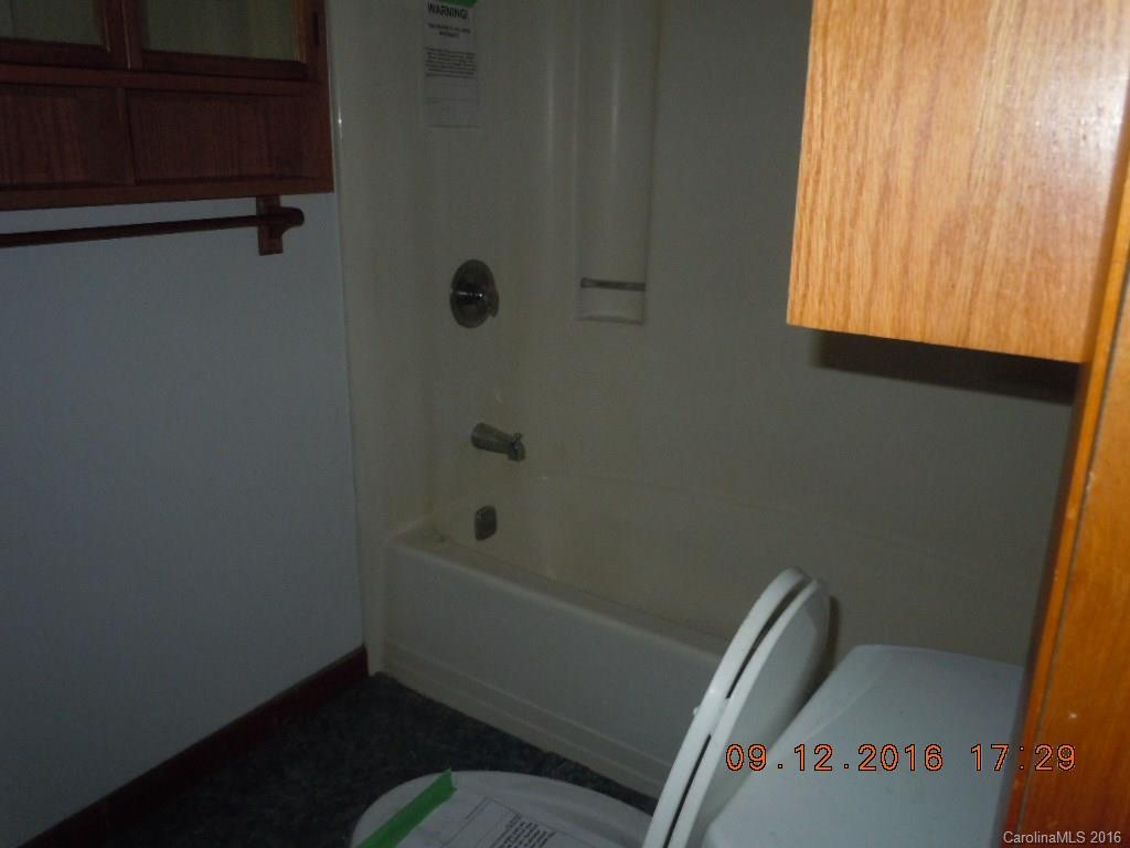 61 Stroupe Road Canton, NC 28716 - Photo 8 of 10 a bathroom with a window and a shower