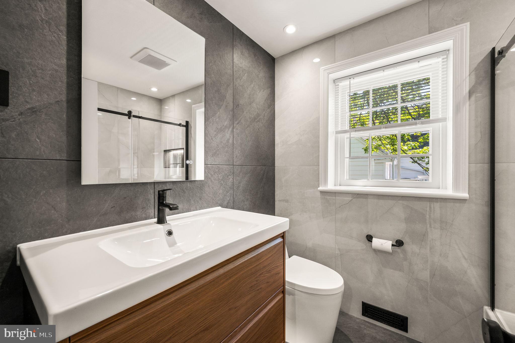 547 West Beechtree Lane Wayne, PA 19087 - Photo 28 of 51 a bathroom with a sink toilet a mirror and window