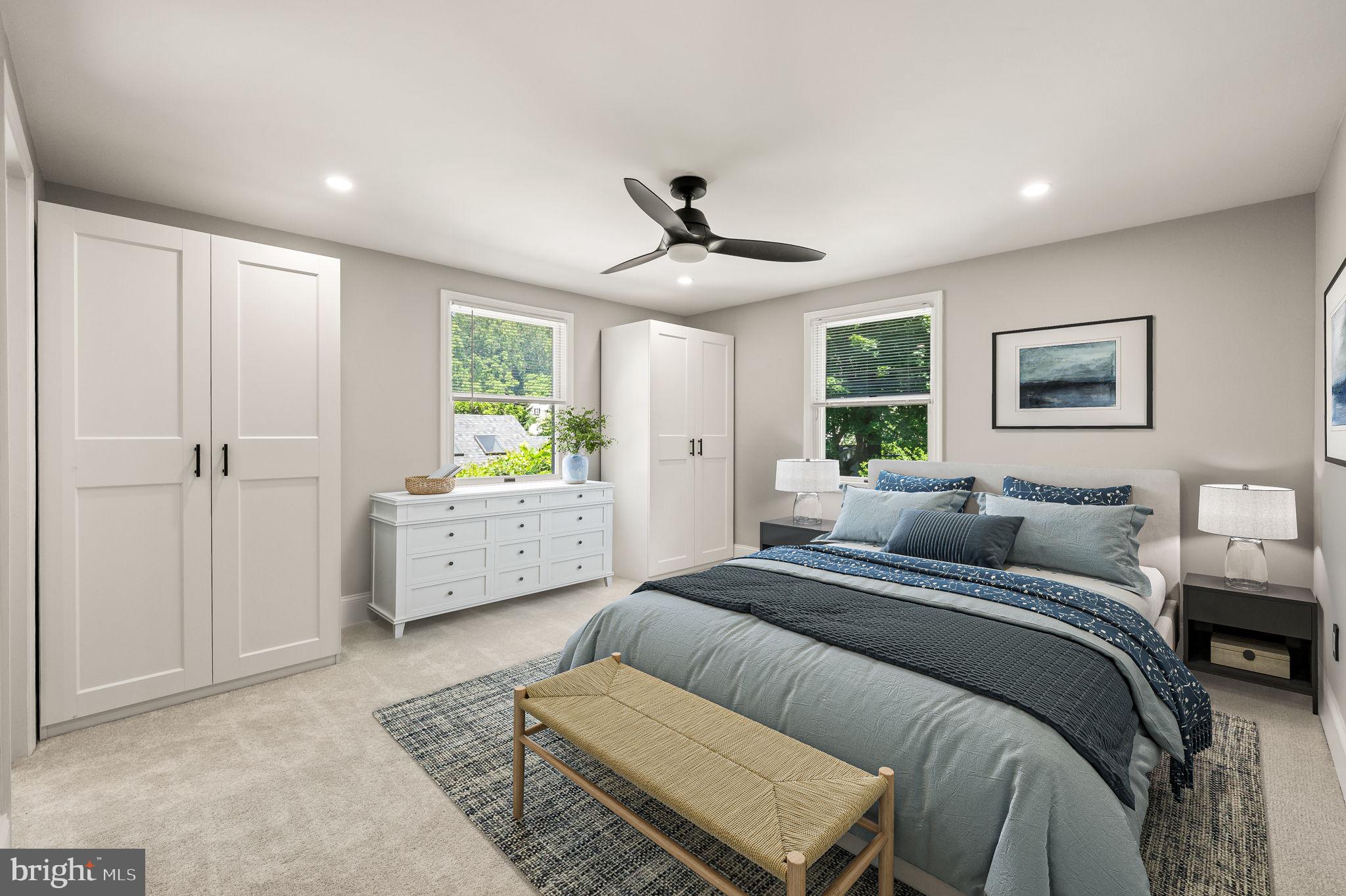 547 West Beechtree Lane Wayne, PA 19087 - Photo 34 of 51 a spacious bedroom with a bed a couch and a chandelier