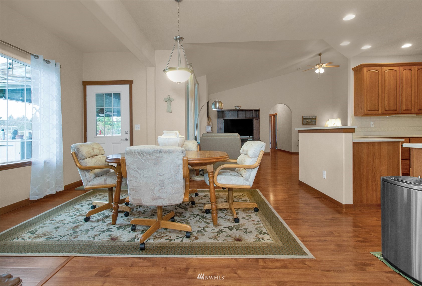 4700 181st Lane Southwest Rochester, WA 98579 - Photo 11 of 30 a view of a dining room with furniture a rug and wooden floor