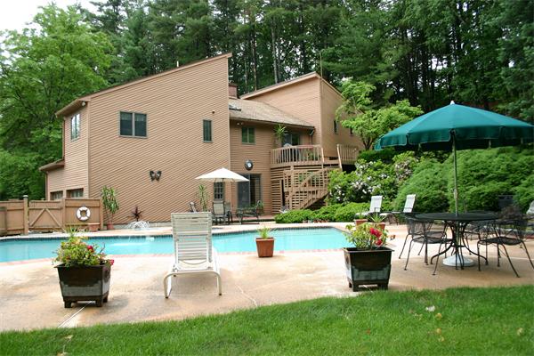 179 Littleton Road Harvard, MA 01451 - Photo 20 of 27 a view of a house with backyard sitting area and garden