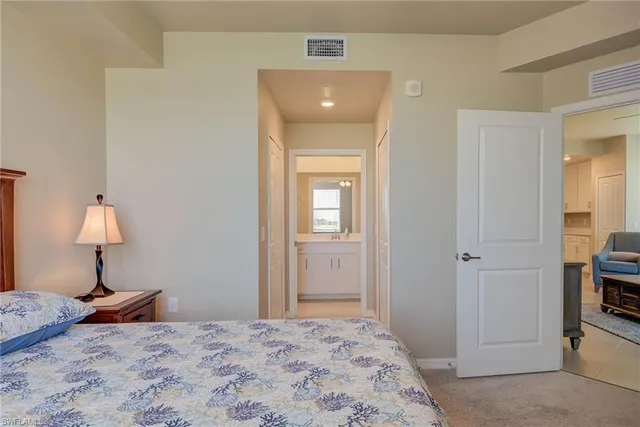 a bedroom with a bed and a lamp