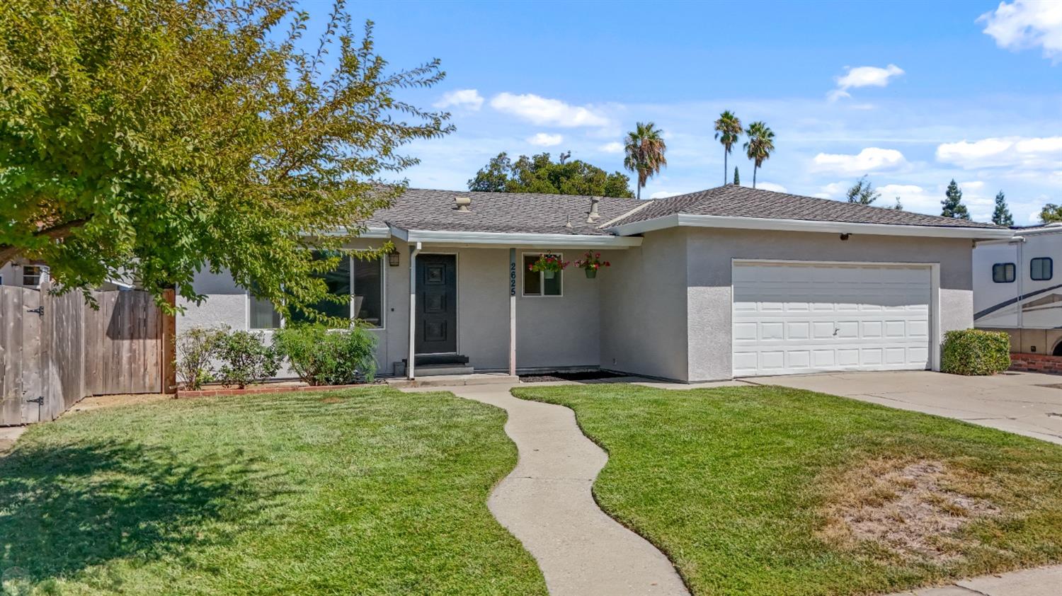 2625 Buttonwillow Avenue Stockton, CA 95207 - Photo 1 of 1 a front view of a house with a yard and garage