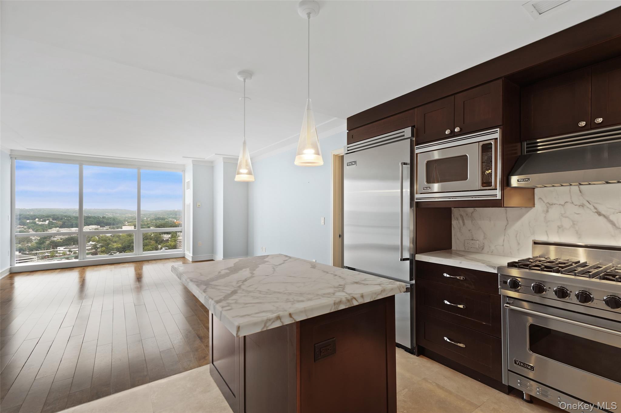 1 Renaissance Square, Unit 25F White Plains, NY 10601 - Photo 1 of 1 a kitchen with a stove a sink and a refrigerator