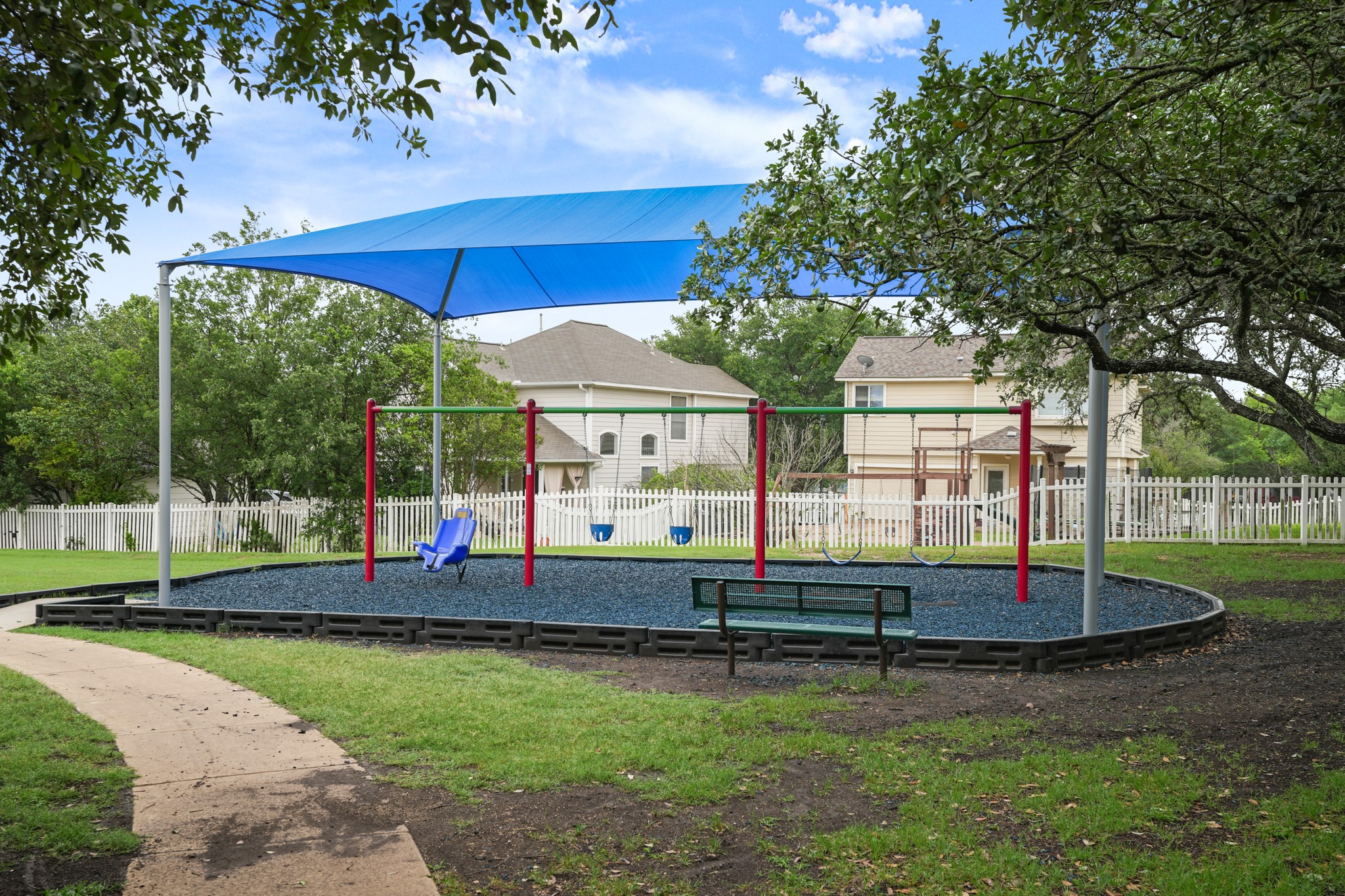 360 Sampson Kyle, TX 78640 - Photo 29 of 36 Outdoor play area featuring a swing set, protective shade structure, and a bench