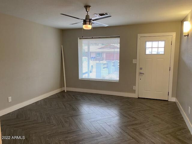 1416 East Del Rio Drive Tempe, AZ 85282 - Photo 9 of 27 an empty room with wooden floor chandelier fan and windows