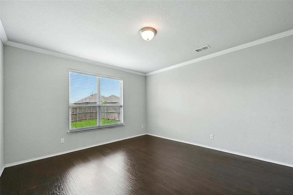 1724 Long Meadow Road Wylie, TX 75098 - Photo 11 of 23 an empty room with wooden floor and windows