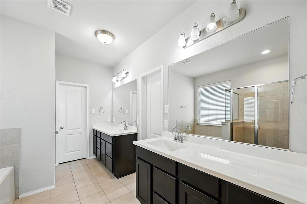 1724 Long Meadow Road Wylie, TX 75098 - Photo 13 of 23 a bathroom with a sink double vanity granite tub shower and a mirror