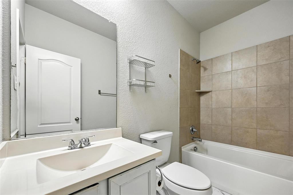 1724 Long Meadow Road Wylie, TX 75098 - Photo 17 of 23 a bathroom with a sink toilet vanity and shower