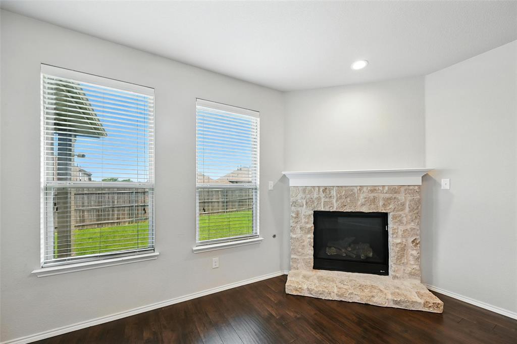 1724 Long Meadow Road Wylie, TX 75098 - Photo 3 of 23 a living room with a fireplace and a table