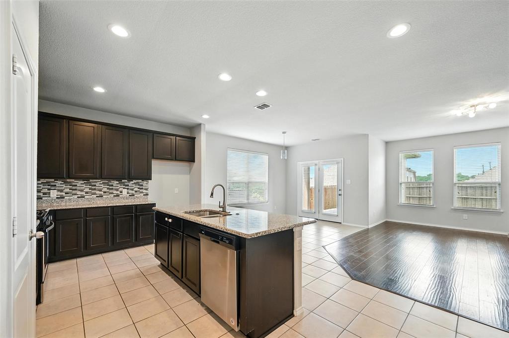 1724 Long Meadow Road Wylie, TX 75098 - Photo 5 of 23 a kitchen with stainless steel appliances granite countertop a stove and a sink