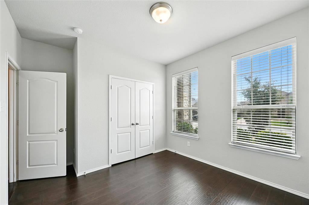 1724 Long Meadow Road Wylie, TX 75098 - Photo 9 of 23 a view of an empty room with wooden floor and a window