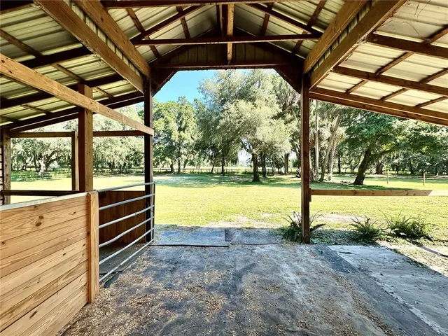 a large kitchen with stainless steel appliances granite countertop a lot of counter space a sink and dishwasher a stove top oven with wooden floor