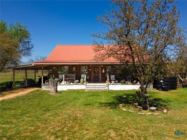 a view of a house with swimming pool and sitting area