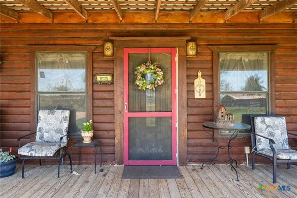 a view of a patio with table and chairs and a barbeque