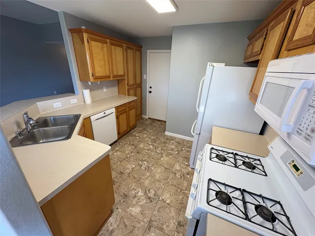 a kitchen with a refrigerator and a stove