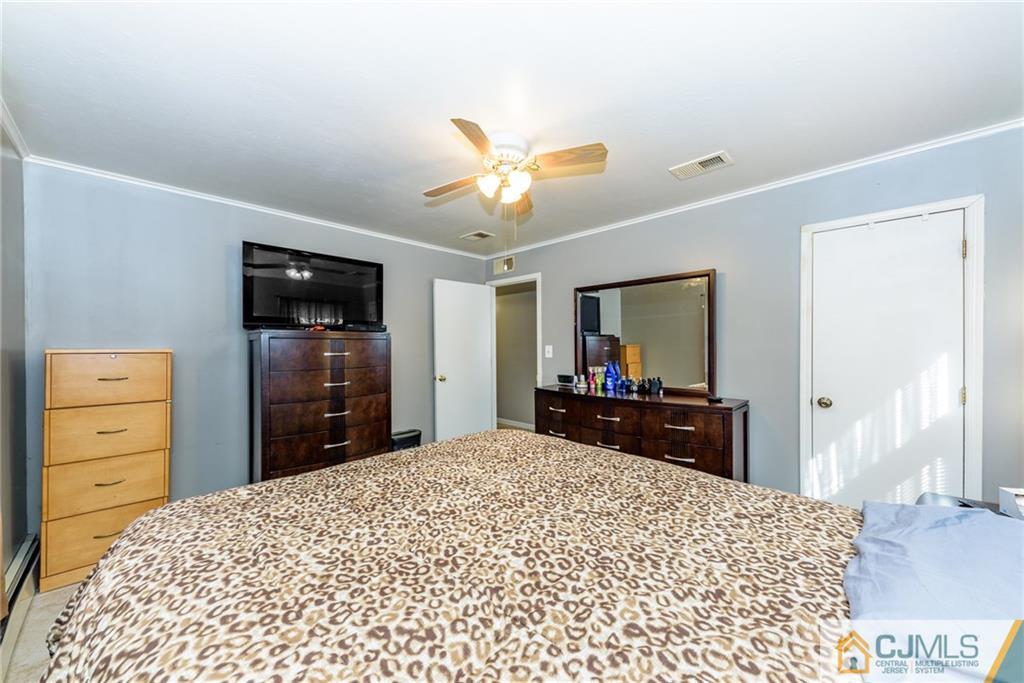 61 Gurley Road Edison, NJ 08817 - Photo 11 of 21 a bedroom with a bed and a flat screen tv