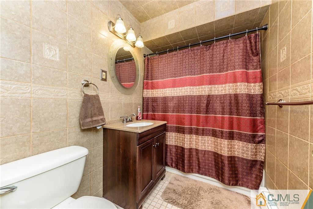 61 Gurley Road Edison, NJ 08817 - Photo 16 of 21 a bathroom with a sink a toilet and shower