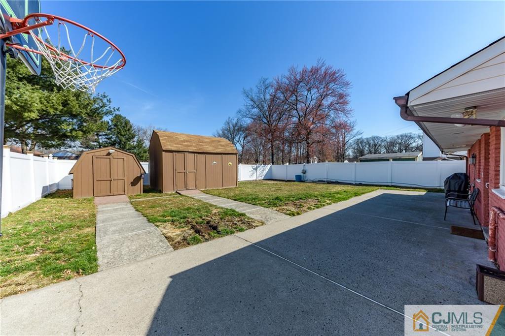 61 Gurley Road Edison, NJ 08817 - Photo 18 of 21 a view of a backyard with brick wall and potted plants