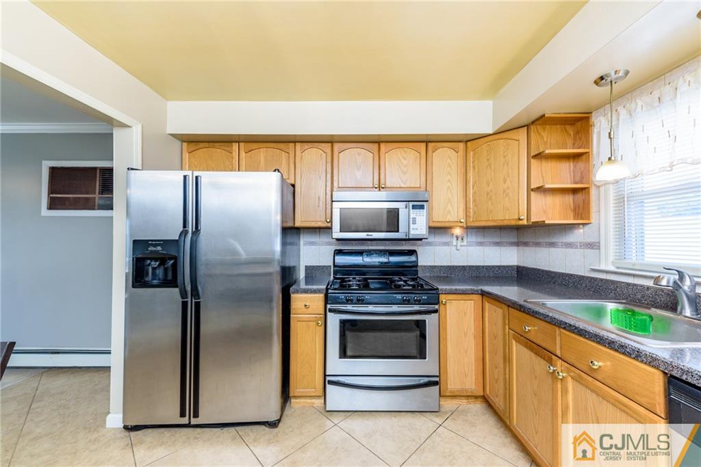 61 Gurley Road Edison, NJ 08817 - Photo 6 of 21 a kitchen with stainless steel appliances granite countertop a refrigerator and a sink