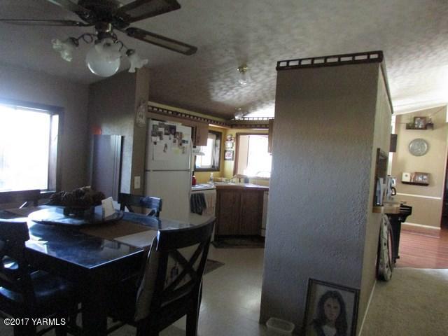 96802 West Good Road Prosser, WA 99350 - Photo 4 of 15 a kitchen with a table chairs and refrigerator