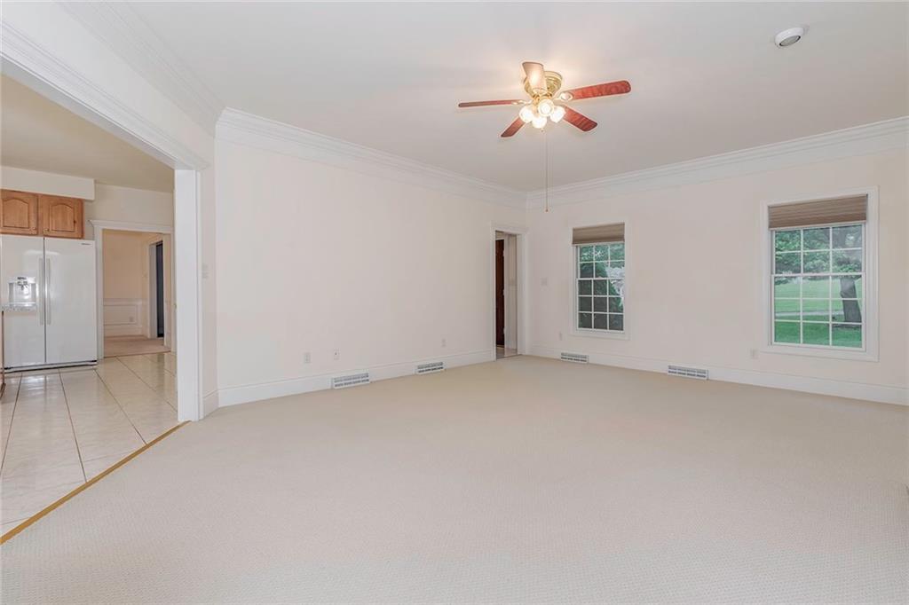 186 Warren Road Warrendale, PA 15086 - Photo 5 of 24 One view of the expansive family room with the extra wide door way leading into the kitchen. The other doorway in the front right leads to the entryway. This room also boasts upgraded door framing, crown molding and custom blinds. In this photo, the doorway to the dining room is in view next to the refrigerator which shows the easy open traffic flow in the layout of this house.