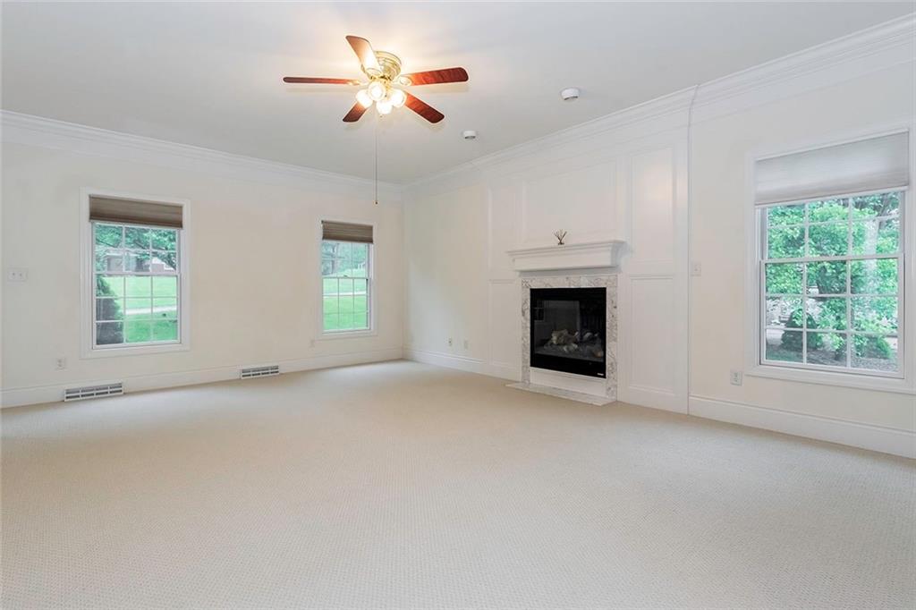 186 Warren Road Warrendale, PA 15086 - Photo 6 of 24 An alternate view of the family room as seen from the kitchen doorway. The gas fireplace is framed beautifully with judges paneling and mantel. The room offers three windows that bring in abundant natural light as well as recessed lighting and an overhead light with ceiling fan.