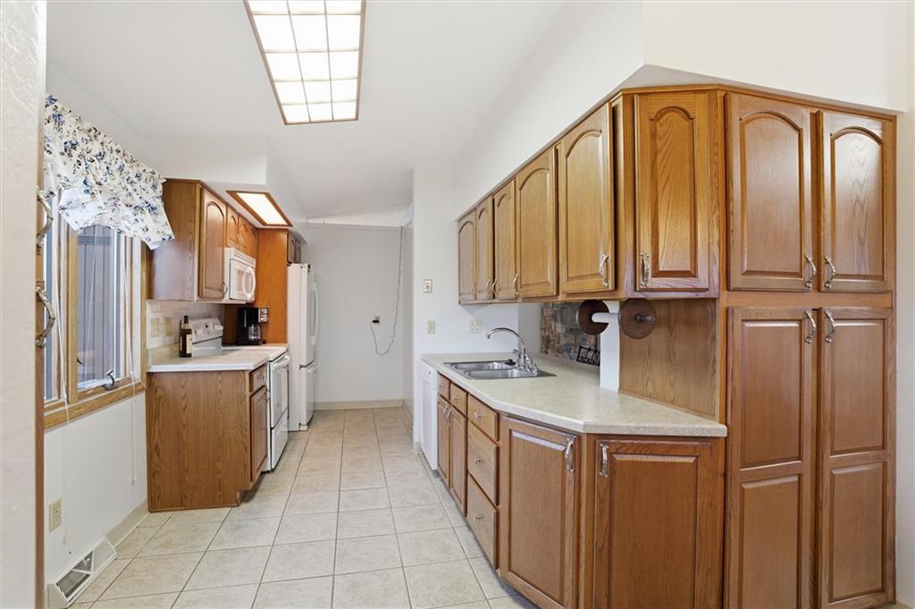 537 Lebanon School Road Belle Vernon, PA 15012 - Photo 11 of 48 a kitchen with stainless steel appliances granite countertop a refrigerator a stove and a sink