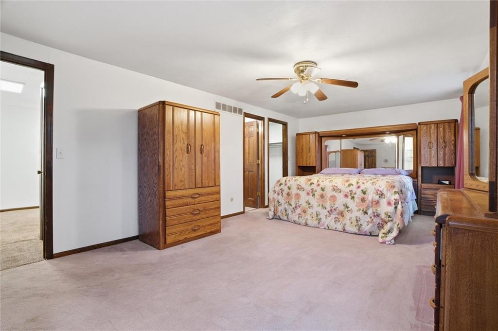 537 Lebanon School Road Belle Vernon, PA 15012 - Photo 17 of 48 a bedroom with a large bed and a chandelier fan