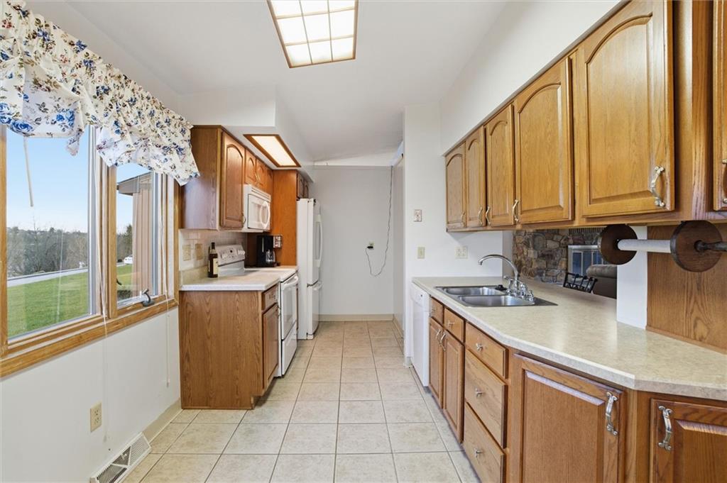 537 Lebanon School Road Belle Vernon, PA 15012 - Photo 10 of 48 a kitchen with stainless steel appliances granite countertop a stove a sink and a refrigerator