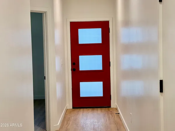 a view of a room with wooden floor