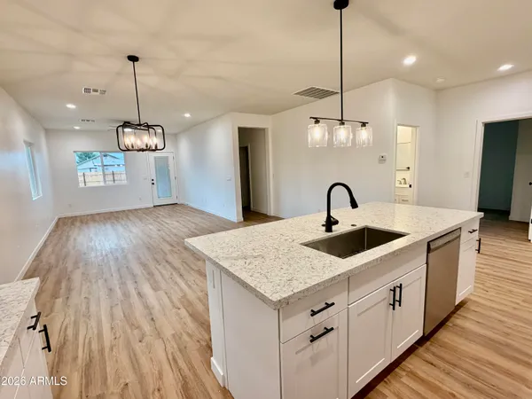 a kitchen with kitchen island a stove a sink and a refrigerator