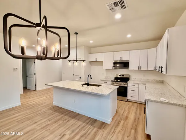 a bathroom with a double vanity sink mirror and tub