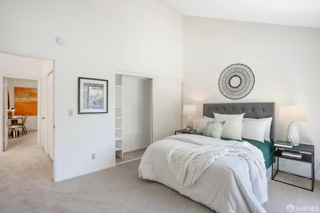 a bedroom with a bed and a table