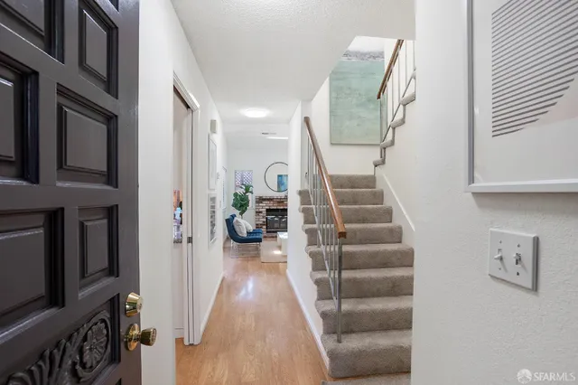 a view of entryway and hall with wooden floor