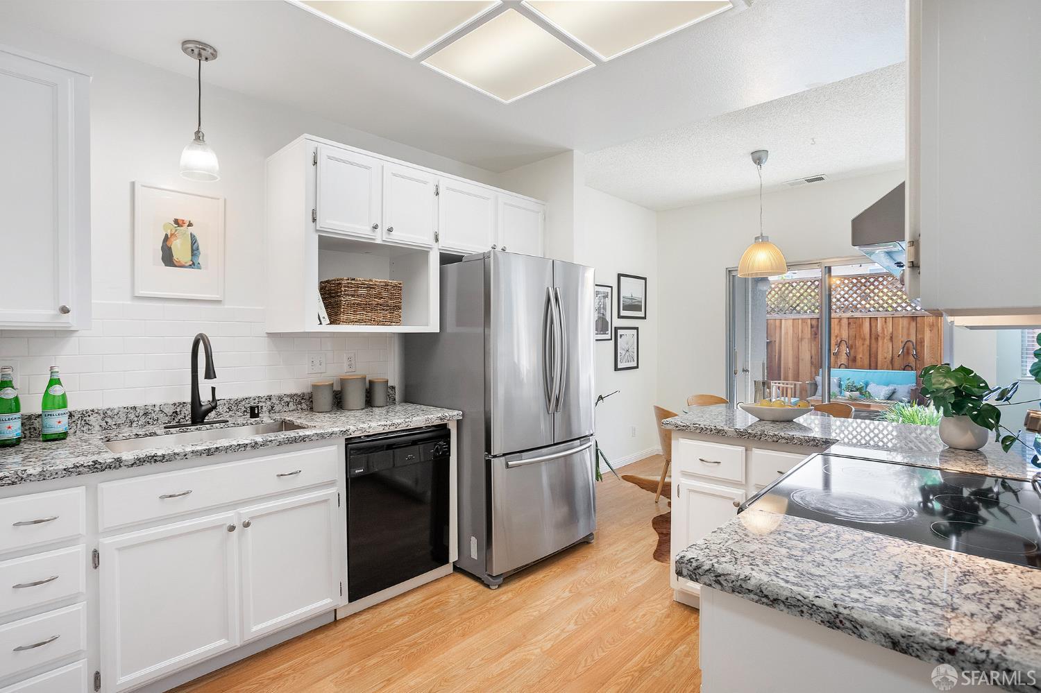 3937 Vine Street Pleasanton, CA 94566 - Photo 4 of 30 a kitchen with stainless steel appliances granite countertop a refrigerator a sink dishwasher a oven with white cabinets and wooden floor