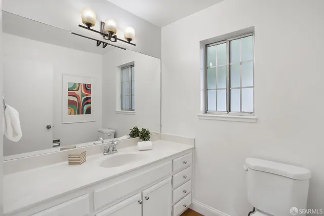 a bathroom with a sink vanity and a mirror