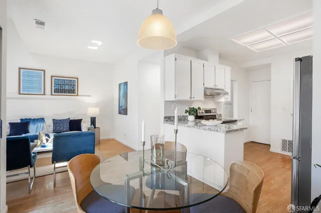 a dining room with furniture and a chandelier
