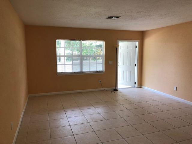 7407 Sebastian Road Fort Pierce, FL 34951 - Photo 3 of 13 an empty room with windows